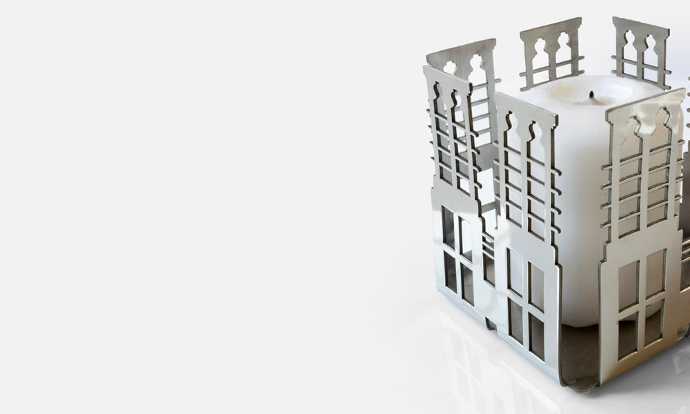 Votive shaped candle design inspired by UAE architecture made with a luxury metal finish designed by Kashida