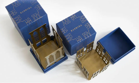 Votive shaped candle design inspired by UAE architecture made with a luxury metal finish designed by Kashida