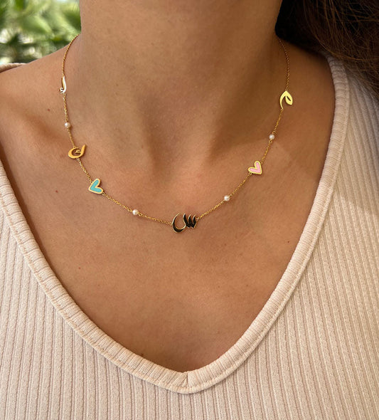 Custom made gold pendant earrings made with Arabic calligraphy letters