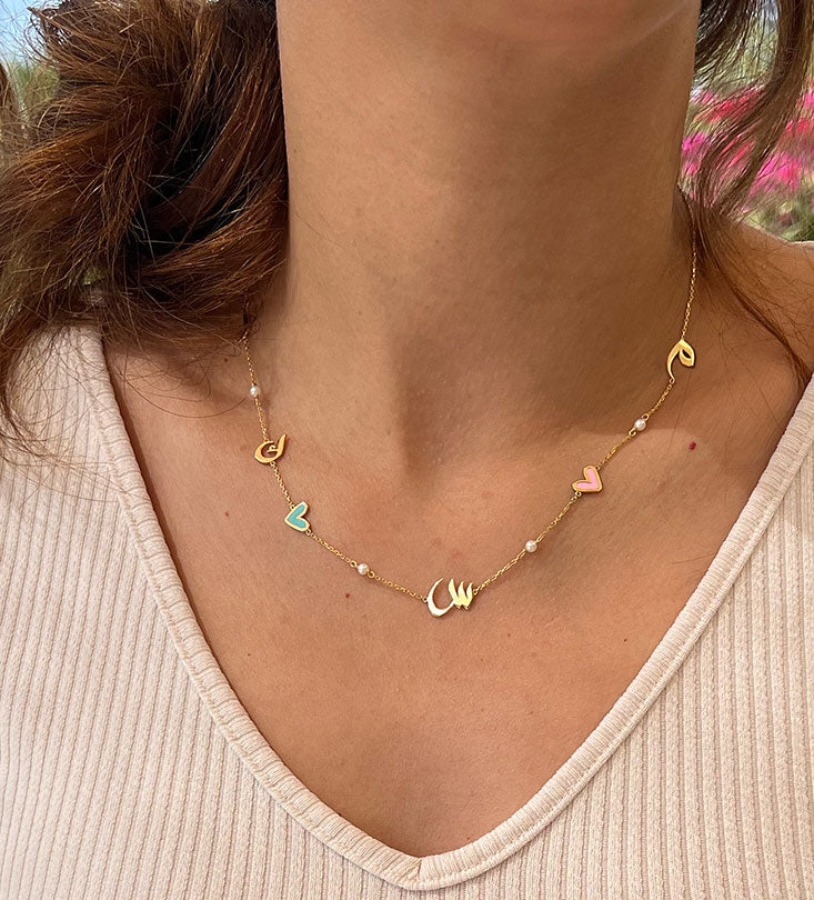 Custom made gold pendant earrings made with Arabic calligraphy letters