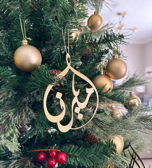 Kashida design's original custom-made metal christmas tree ornaments with personalised names in Arabic calligraphy