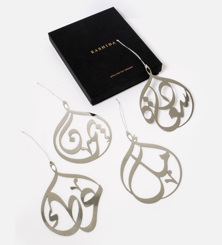 Kashida design's original custom-made metal christmas tree ornaments with personalised names in Arabic calligraphy