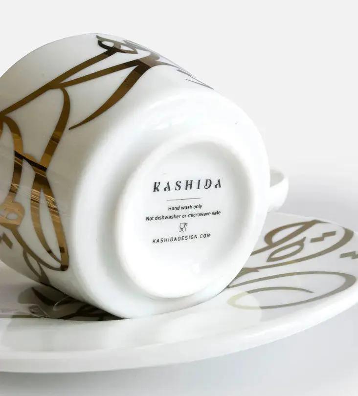 Contemporary gold and silver porcelain espresso cups with Arabic graffiti print