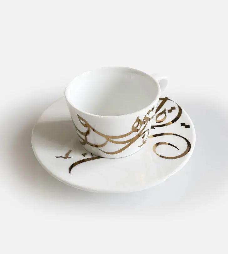 Contemporary gold and silver porcelain espresso cups with Arabic graffiti print