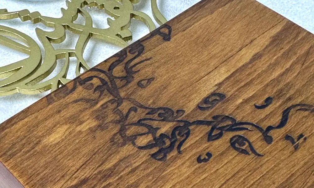 Luxury trophy made of lasercut steel and solid walnut wood featuring a falcon silhouette filled with Arabic calligraphy, designed by Kashida.