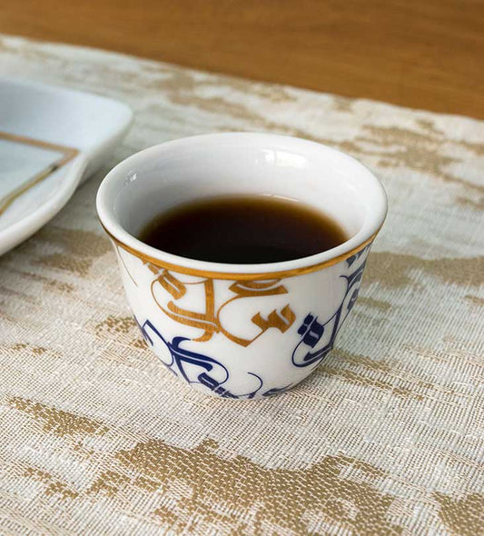 Traditional Arabic coffee cup finjal in royal blue and gold Arabic calligraphy pattern
