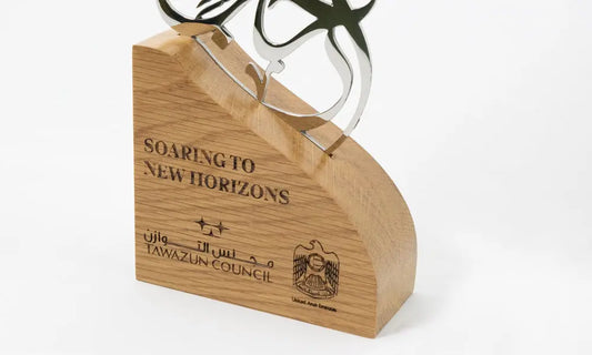 Arabic calligraphy trophy design by Kashida with mirror polished steel mounted on a solid wooden base