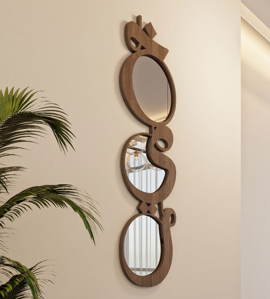Modern contemporary wooden mirrors in Arabic calligraphy that reads khayr, meaning goodness