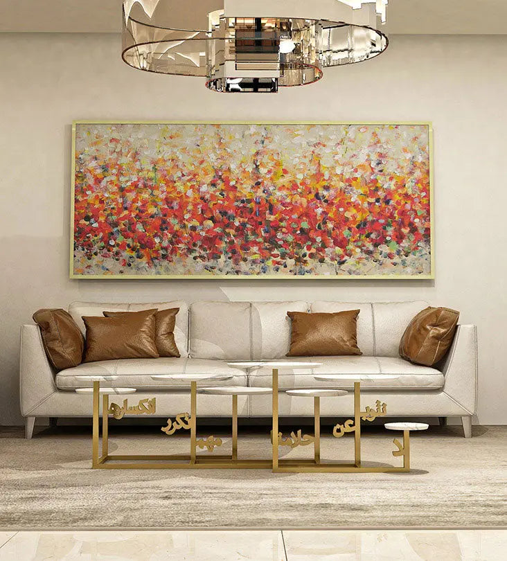 front view of multi-tiered coffee table with arabic calligraphy steel base and marble table tops