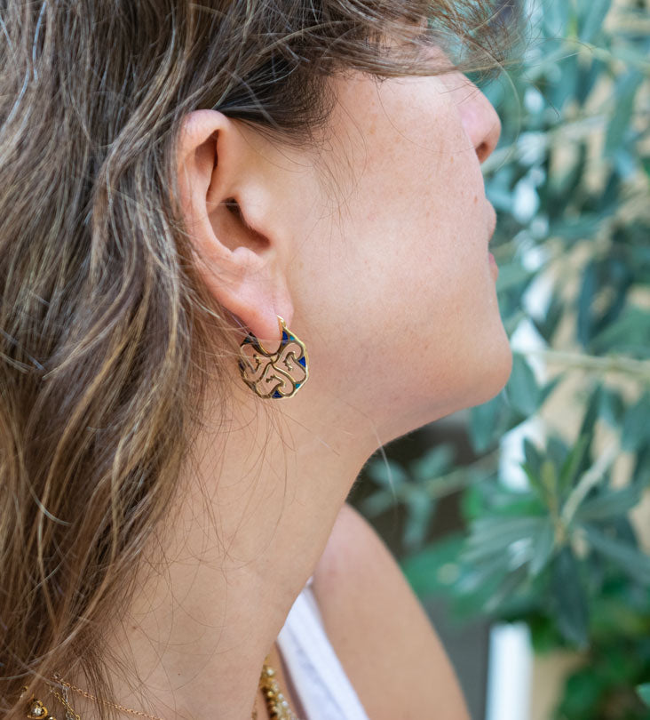 Custom made gold earrings made with Arabic calligraphy letters in arabesque pattern shapes