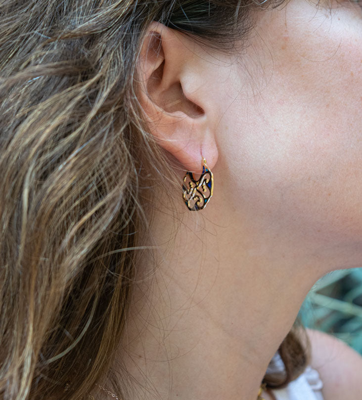 Custom made gold earrings made with Arabic calligraphy letters in arabesque pattern shapes