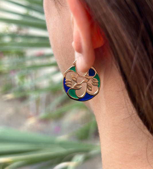 Custom made gold earrings made with Arabic calligraphy letters in arabesque pattern shapes