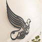 Arabic calligraphy in bird shape that reads God Bless Our Home