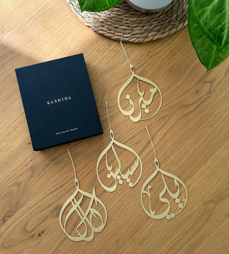 Kashida design's original custom-made metal christmas tree ornaments with personalised names in Arabic calligraphy