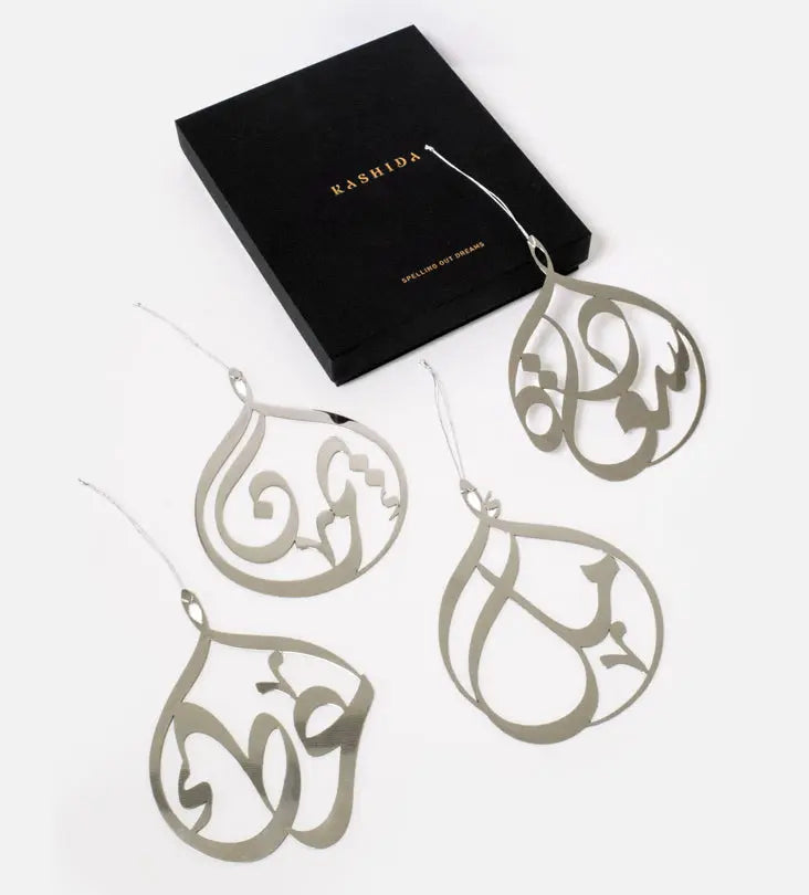 Kashida design's original custom-made metal christmas tree ornaments with personalised names in Arabic calligraphy