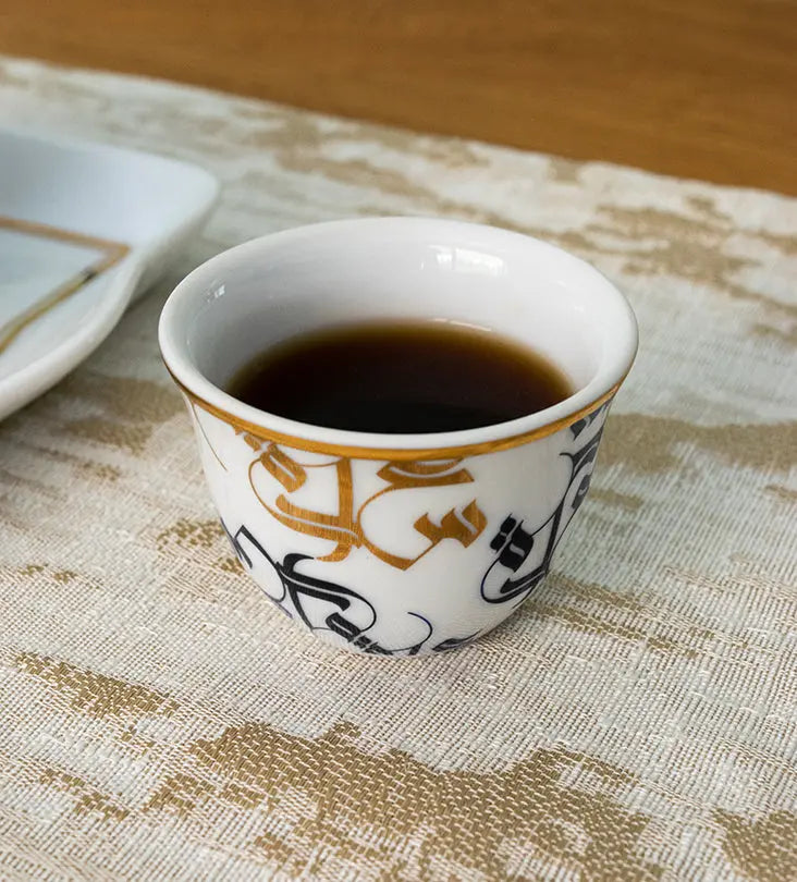 Traditional Arabic coffee cup finjal in royal blue and gold Arabic calligraphy pattern