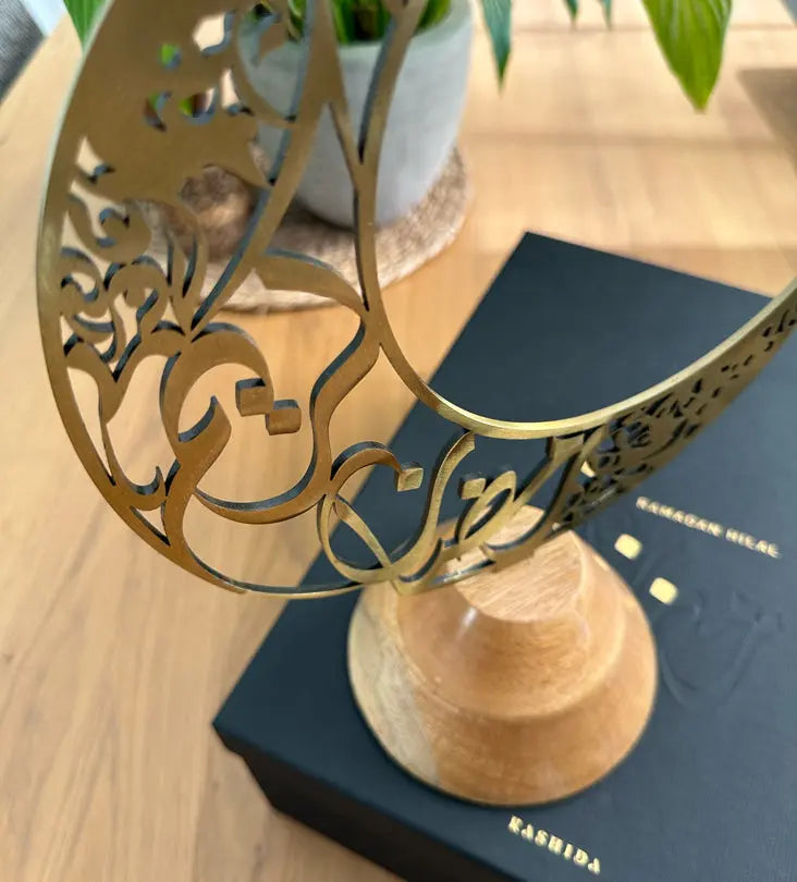 Arabic Calligraphy crescent home décor for Ramadan by Kashida design, in the shape of a Ramadan Hilal with Arabic calligraphy