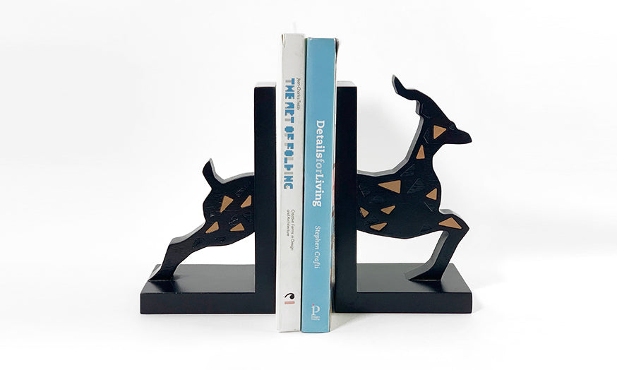 A set of two wooden bookends shaped like a gazelle with copper inlay for Miral corporation in Abu Dhabi, UAE