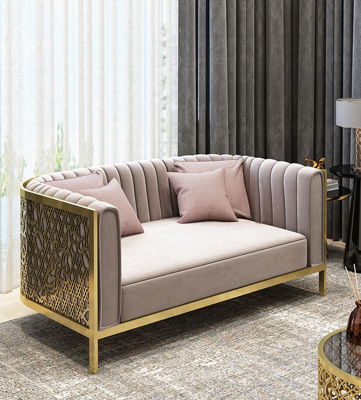 Polished gold and blush pink luxury sofa with arabesque patterns and arabic letters