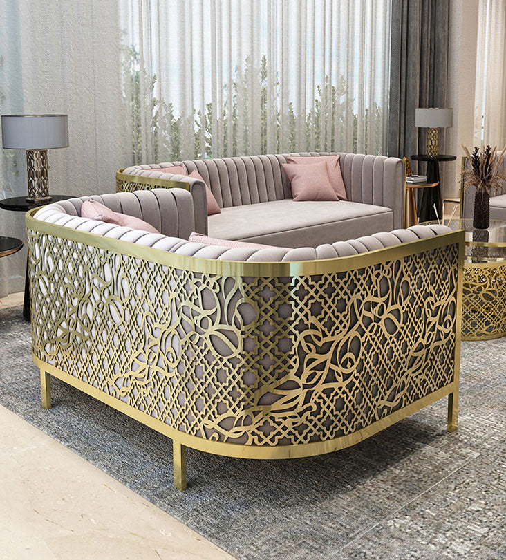 Polished gold and blush pink luxury sofa with arabesque patterns and arabic letters