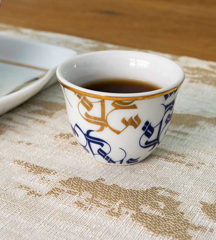 Traditional Arabic coffee cup finjal in royal blue and gold Arabic calligraphy pattern