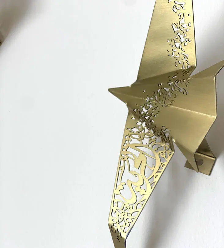 Beautiful brass plated decorative wall hangers shaped like origami birds with modern Arabic calligraphy designed by Kashida