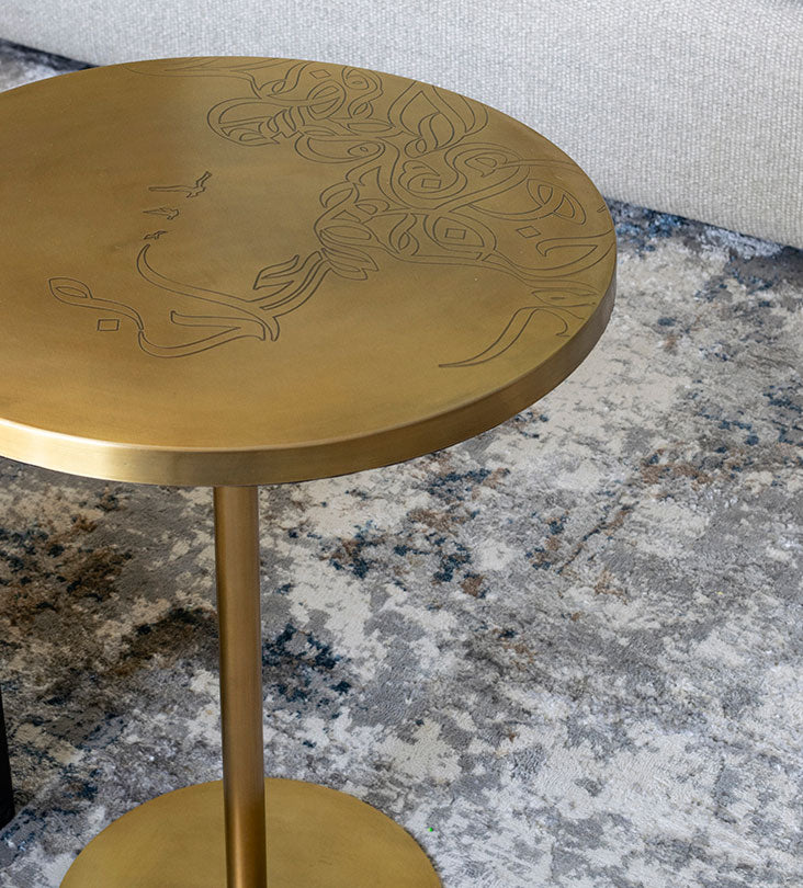 Brass round table with contemporary Arabic graffiti etchingsBrass round table with contemporary Arabic graffiti etchings
