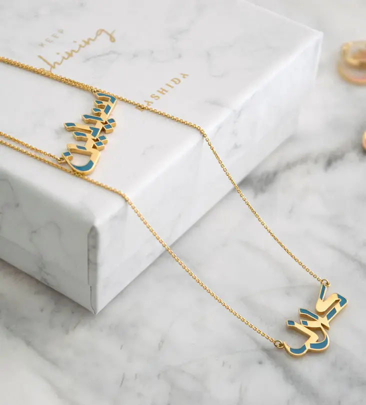 Custom made gold jewelry necklace with modern Arabic calligraphy 