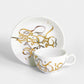 Contemporary gold and silver porcelain tea cup and saucer with Arabic graffiti letters