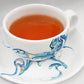 Contemporary porcelain tea cup and saucer with Arabic calligraphy fluid art