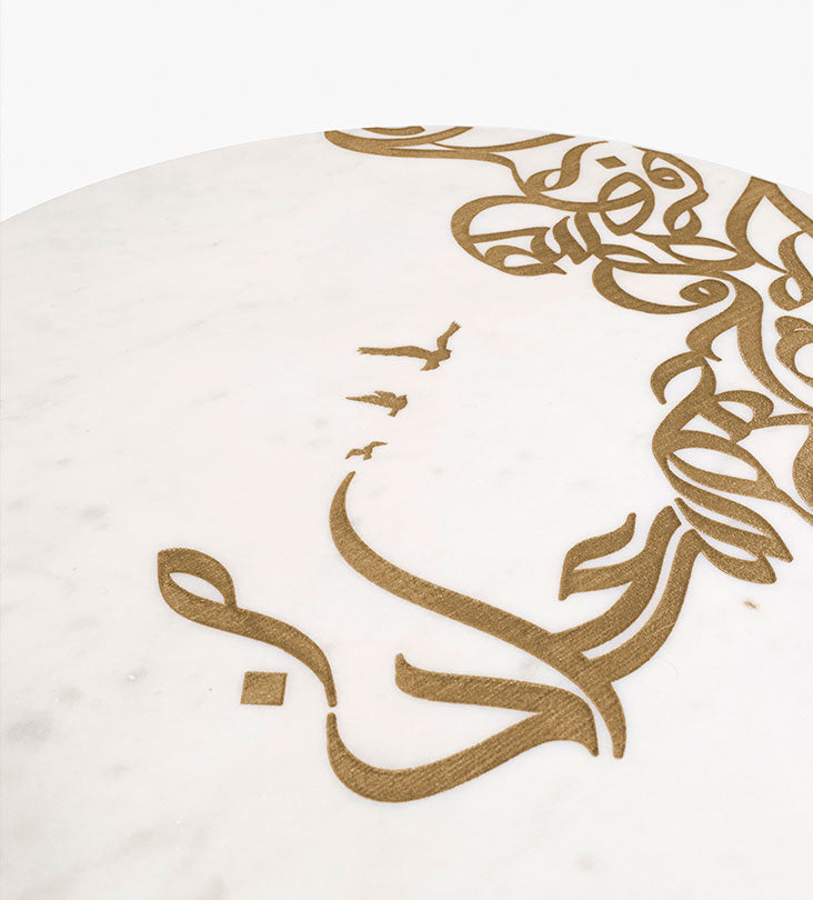 A set of two white marble side tables with contemporary Arabic graffiti etchings and a gold steel base