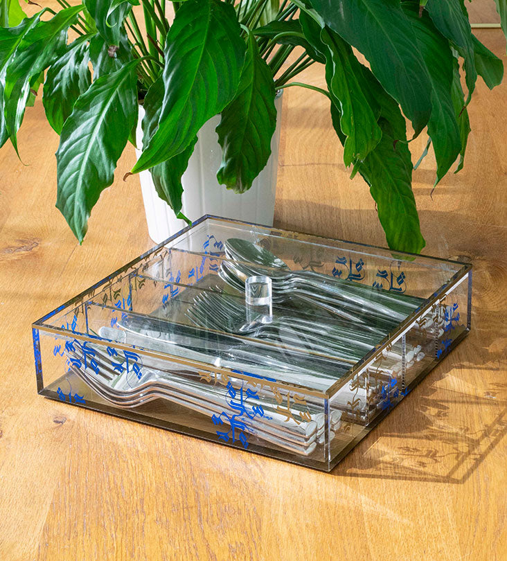 Transparent acrylic cutlery holder with four compartments featuring modern Arabic calligraphy by Kashida